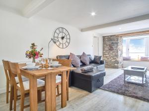 a living room with a table and a couch at Imperial Apartment in Oban