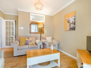 a living room with a couch and a table at Anchors Away - 29566 in Blue Anchor