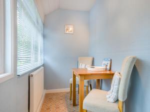 a small dining room with a table and chairs at Anchors Away - 29566 in Blue Anchor