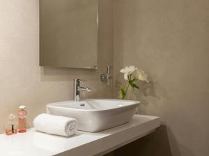 a bathroom with a white sink and a mirror at Hotel IBY in New Delhi +28 photos