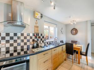 a kitchen with a sink and a stove top oven at 6 Mount Brioni in Downderry