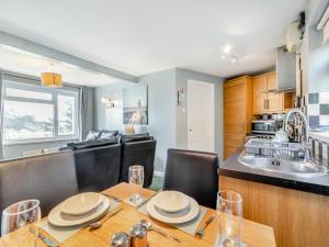 a kitchen and dining room with a table and chairs at 6 Mount Brioni in Downderry