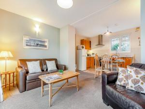 a living room with a couch and a table at 12 Mount Brioni in Downderry