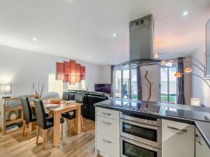 a kitchen with a table and a dining room at 21 Mount Brioni in Downderry