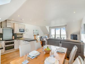 a kitchen and dining room with a table and chairs at 18 Mount Brioni in Downderry