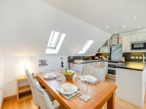 a kitchen and dining room with a wooden table at 18 Mount Brioni in Downderry