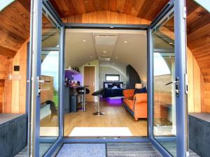 a glass house with a living room and dining room at Dunfion - Uk7835 in Brodick