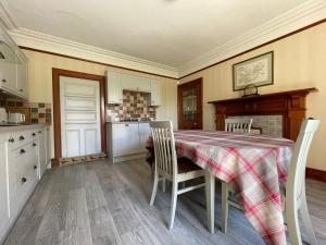 a kitchen with a table and chairs in a kitchen at Balloan House-Uk7383 in Dornoch