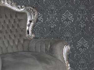 a close up of a chair in front of a wall at Coastal Gem - Uk2773 in Llandudno