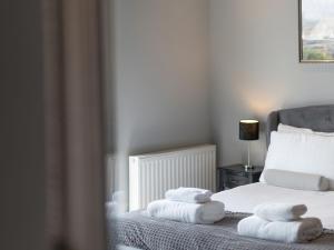 a bedroom with a bed with towels on it at Coastal Gem - Uk2773 in Llandudno +10 photos