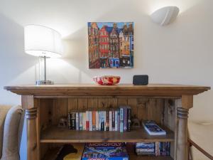 a wooden table with a book shelf with books at 7A - Uk7350 in Edinburgh