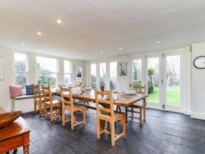 a dining room with a wooden table and chairs at Downedge in Brading
