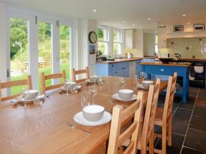 a kitchen and dining room with a wooden table at Downedge in Brading