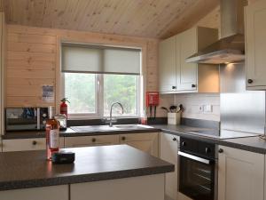 a kitchen with a sink and a window at Ben Klibreck in Kinloss
