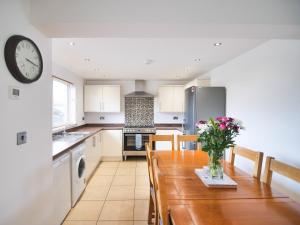 a kitchen with a table with a vase of flowers on it at Cottage 6 - Ukc3183 in York