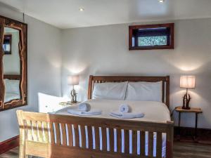 a bedroom with a bed with two towels on it at Anne's Cottage - Uk7782 in Newton Stewart