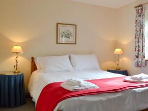 a bedroom with a bed with towels on it at The Walton - Ukc3232 in Onibury