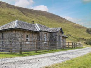 an old stone house on the side of a hill at Marble Lodge - Uk7635 in Pitlochry