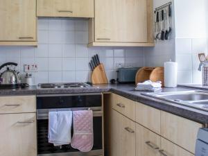 a kitchen with a stove and a sink with towels at Marble Lodge - Uk7635 in Pitlochry