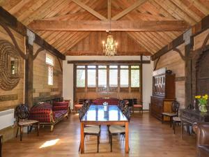a large living room with a table and chairs at The Timber Store in Hardham