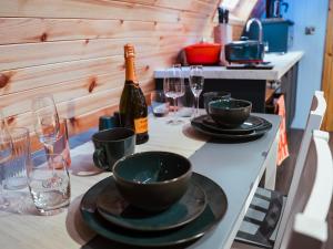 a table with a bottle of wine and plates and glasses at Chestnut-Uk7586 in Stewarton
