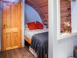 a small bedroom with a bed and a door at Chestnut-Uk7586 in Stewarton