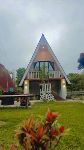 a house with a porch and a bench in front of it at VILA RINJANI PARADAIS IIn in Sajang