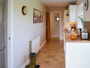 a kitchen with a counter and a counter top at The Byre in Kirkcudbright