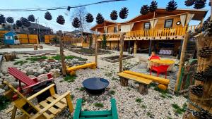 a playground with colorful chairs and a house at Green Owl in Dedoplis Tskaro