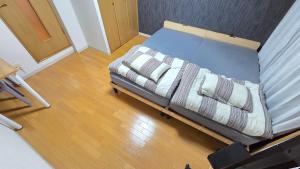 an overhead view of a bed with pillows on it at MORI Apartment Near namba in Osaka