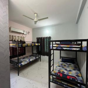 two sets of bunk beds in a room at The Human Nest Coliving in Bhubaneshwar