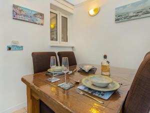 a dining room table with two glasses and a bottle of wine at The Garden Flat in Torquay