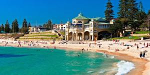 a group of people on a beach in front of a building at il Villinno on Dalton - Great Location in Mosman Park