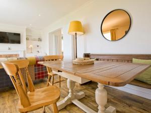 a dining room with a table and a mirror at Edenville in Girthon