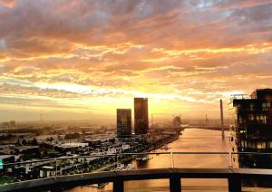 a view of a river in a city at sunset at Melbourne Lifestyle Apartments - Best Views on Collins in Melbourne +89 photos