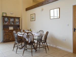 a dining room with a table and chairs at The Hayloft-W42941 in Burn