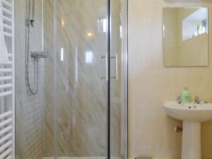 a bathroom with a shower and a sink at The Hayloft-W42941 in Burn +12 photos