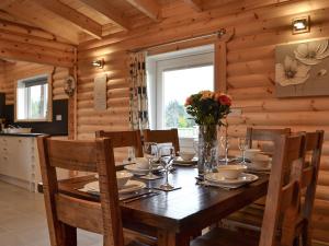 a dining room with a table in a log cabin at Teal Lodge- Ukc2565 in Burn