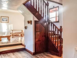 a hallway with a wooden door in a house at Merrick Cottage - Uk7783 in Newton Stewart +6 photos
