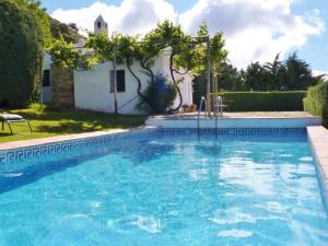 a swimming pool in a yard with a house at Belvilla by OYO Casa Torcalillos in La Joya