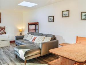 a living room with a couch and a table at Maberry Cottage - Uk7784 in Newton Stewart