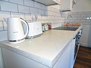 a kitchen counter with two coffee makers on it at Great Orme - Uk2775 in Llandudno