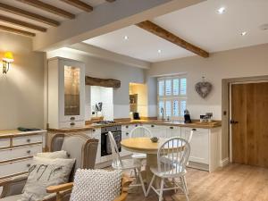 a kitchen with a table and chairs in a room at Bailey Cottage in Skipton