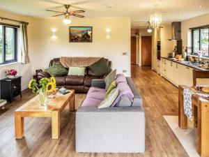 a living room with a couch and a table at Caban Nant Ddu - Ukc8194 in Dolau