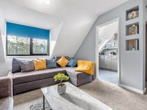 a living room with a couch and a table at Sandyford Apartment in Jesmond