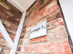 a sign on the side of a brick wall at Cottage 2 - Ukc3179 in York