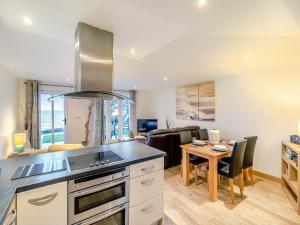 a kitchen with a table and a dining room at 20 Mount Brioni in Downderry