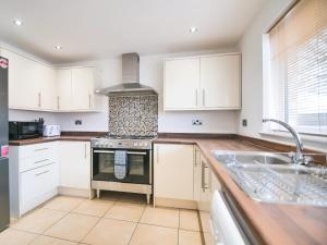 a kitchen with white cabinets and a stove top oven at Cottage 8 - Ukc3185 in York