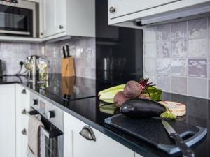 a kitchen with a counter with vegetables on it at Lavender Cottage - Ukc4695 in Kilkhampton +11 photos