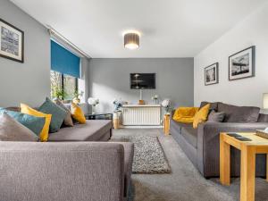 a living room with two couches and a tv at Ouseburn Apartment in Jesmond